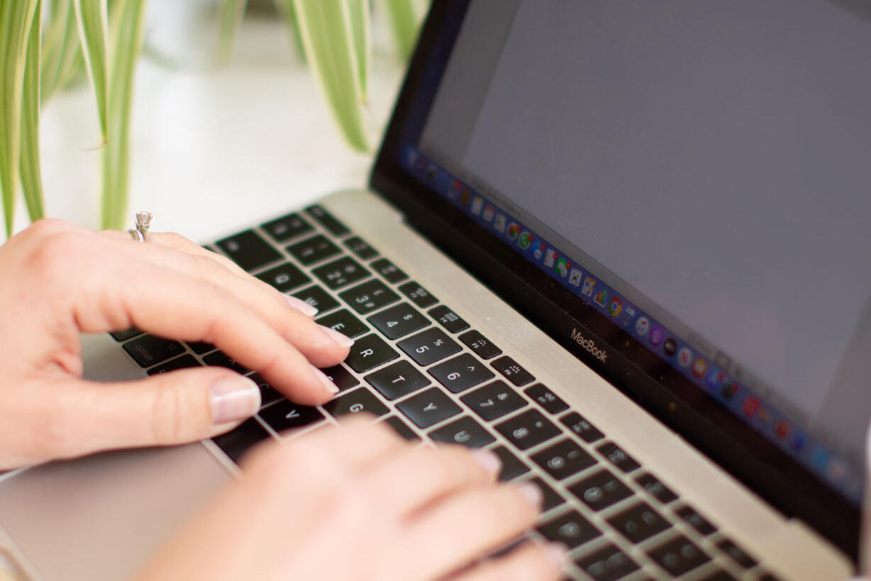 Image shows hands typing on a keyboard